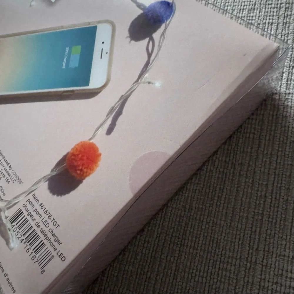 NWT LED phone charger with multicolored Pom-poms